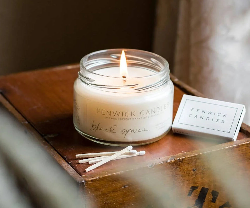 Candle on a wooden tray with matches